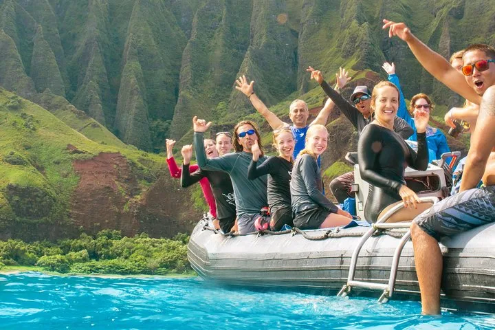 Small raft entering a sea cave on a Na Pali Coast boat tour from Port Allen, Kauai